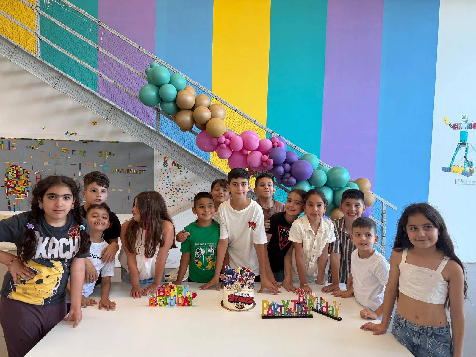 Children celebrating around a birthday cake at MasterKids