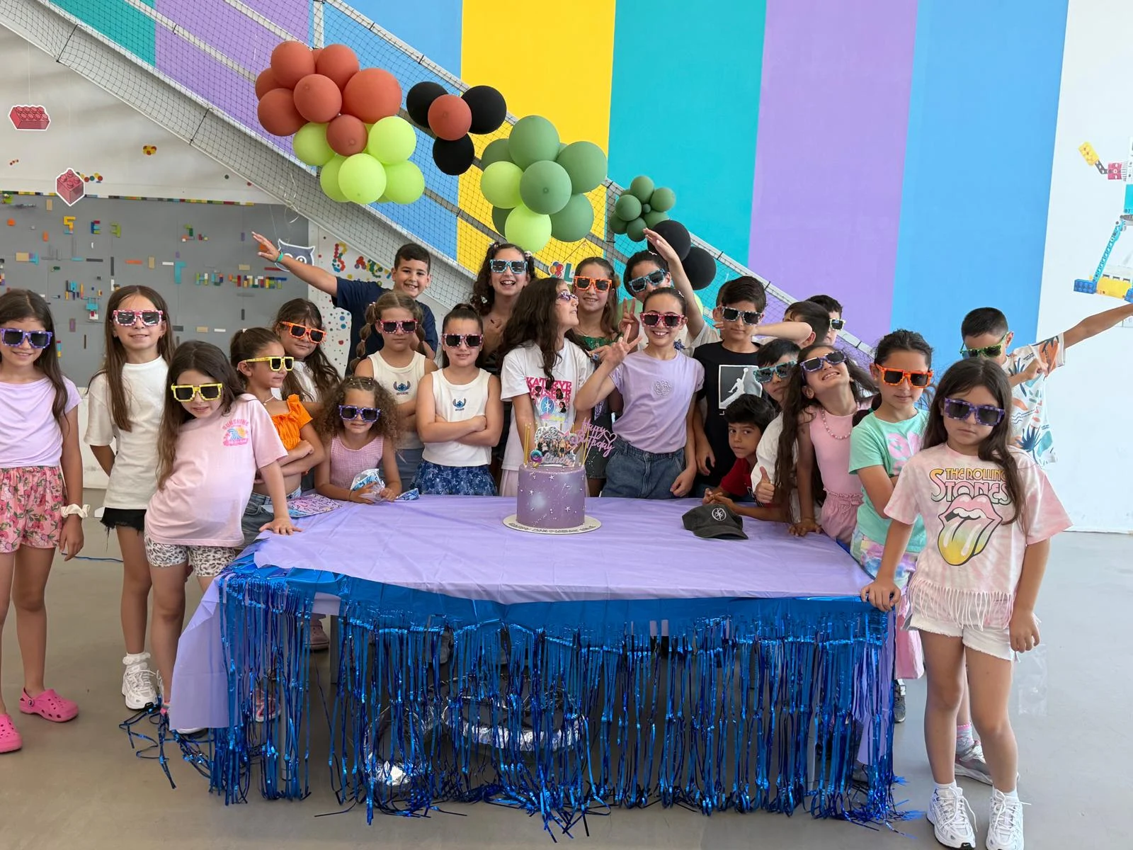 Friends wearing colourful party glasses at MasterKids