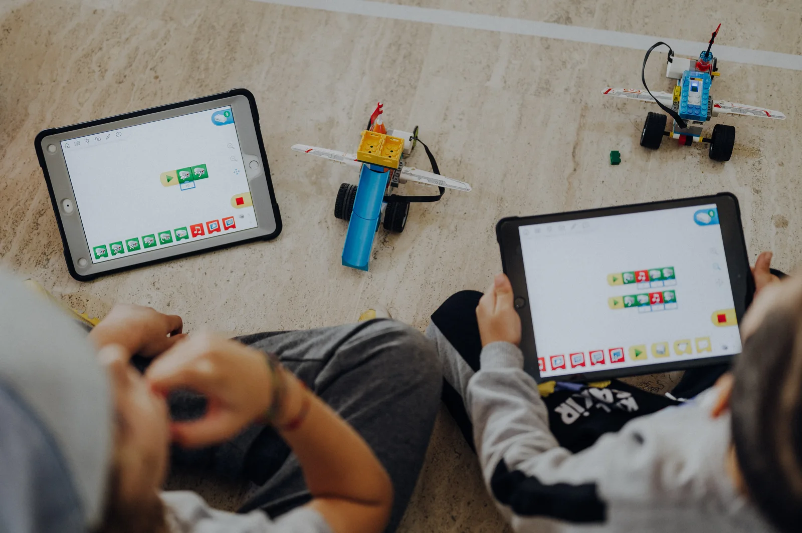Children programming their robots with tablets