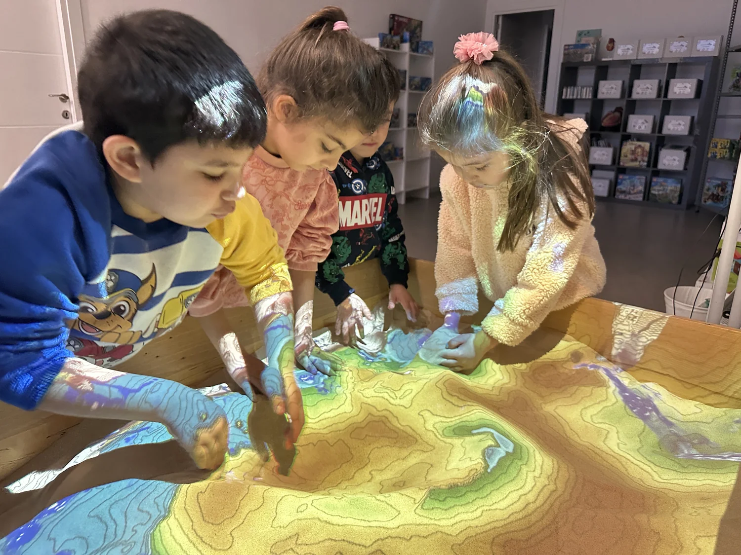 Children exploring a projected landscape together at MasterKids